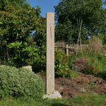 Garden sculpture showing bullrushes carved on a large standing stone